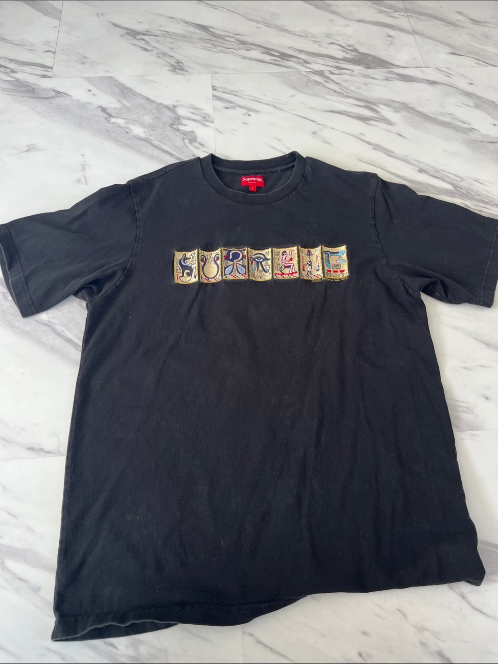 Supreme Black Short-Sleeve Tee with Multicolor Patch Graphic；100% cotton.
